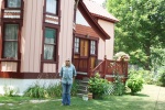 Jon in front of his house